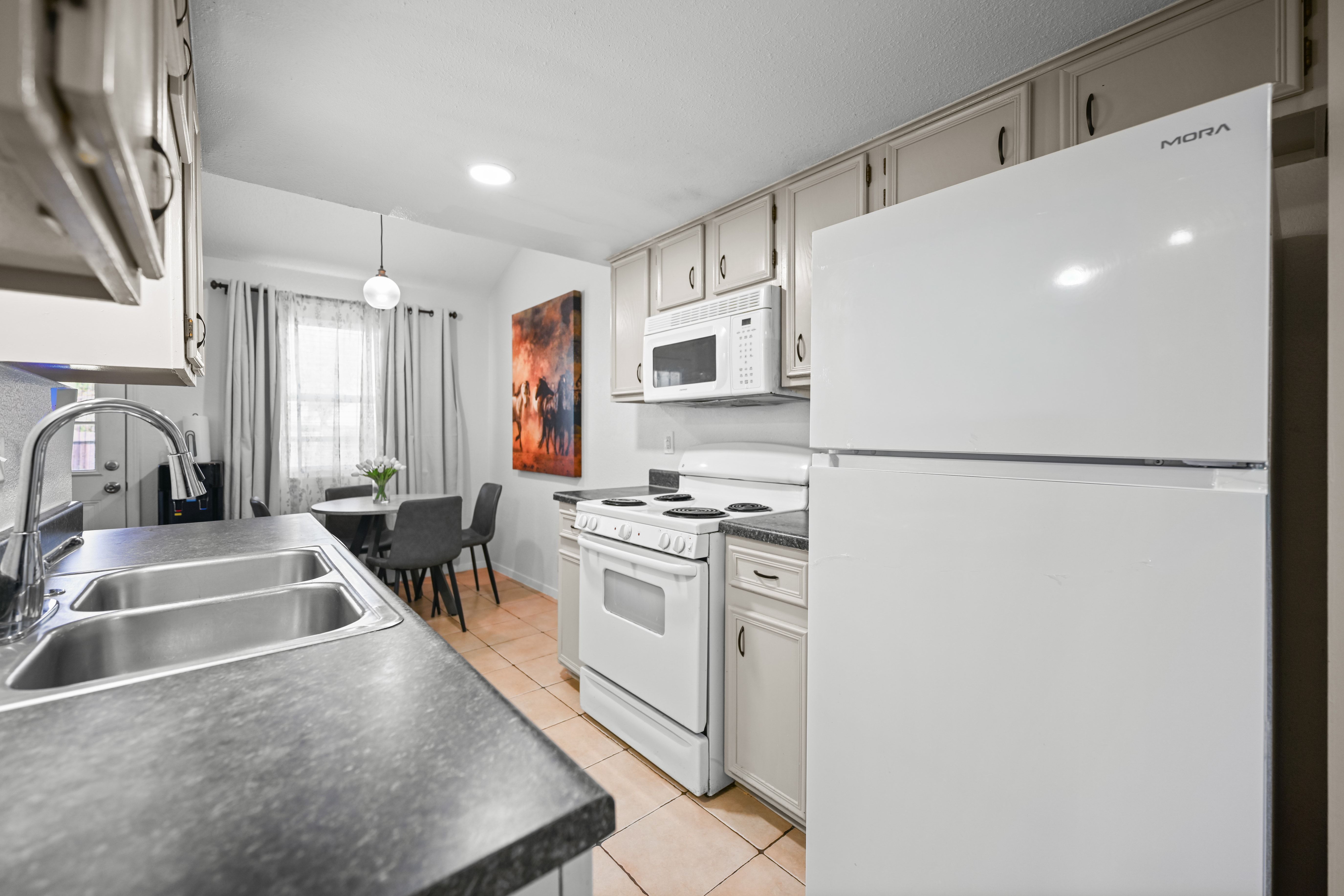 8710 Clearbrook Trail Austin, TX 78729 - Photo 21 of 28 a kitchen with stainless steel appliances granite countertop a sink stove and refrigerator