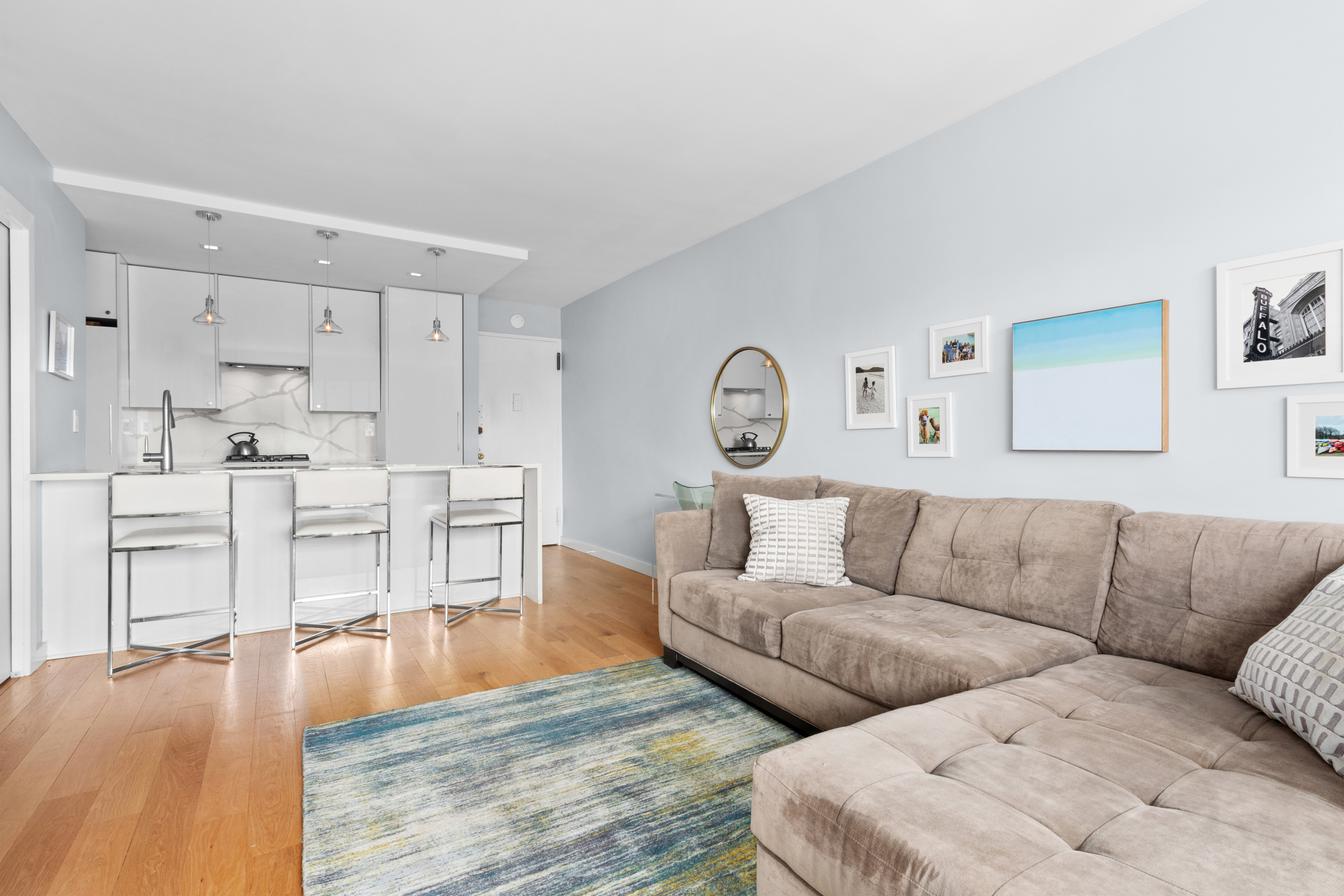201 West 21st Street, Unit 15J Manhattan, NY 10011 - Photo 2 of 6 a living room with furniture and a couch