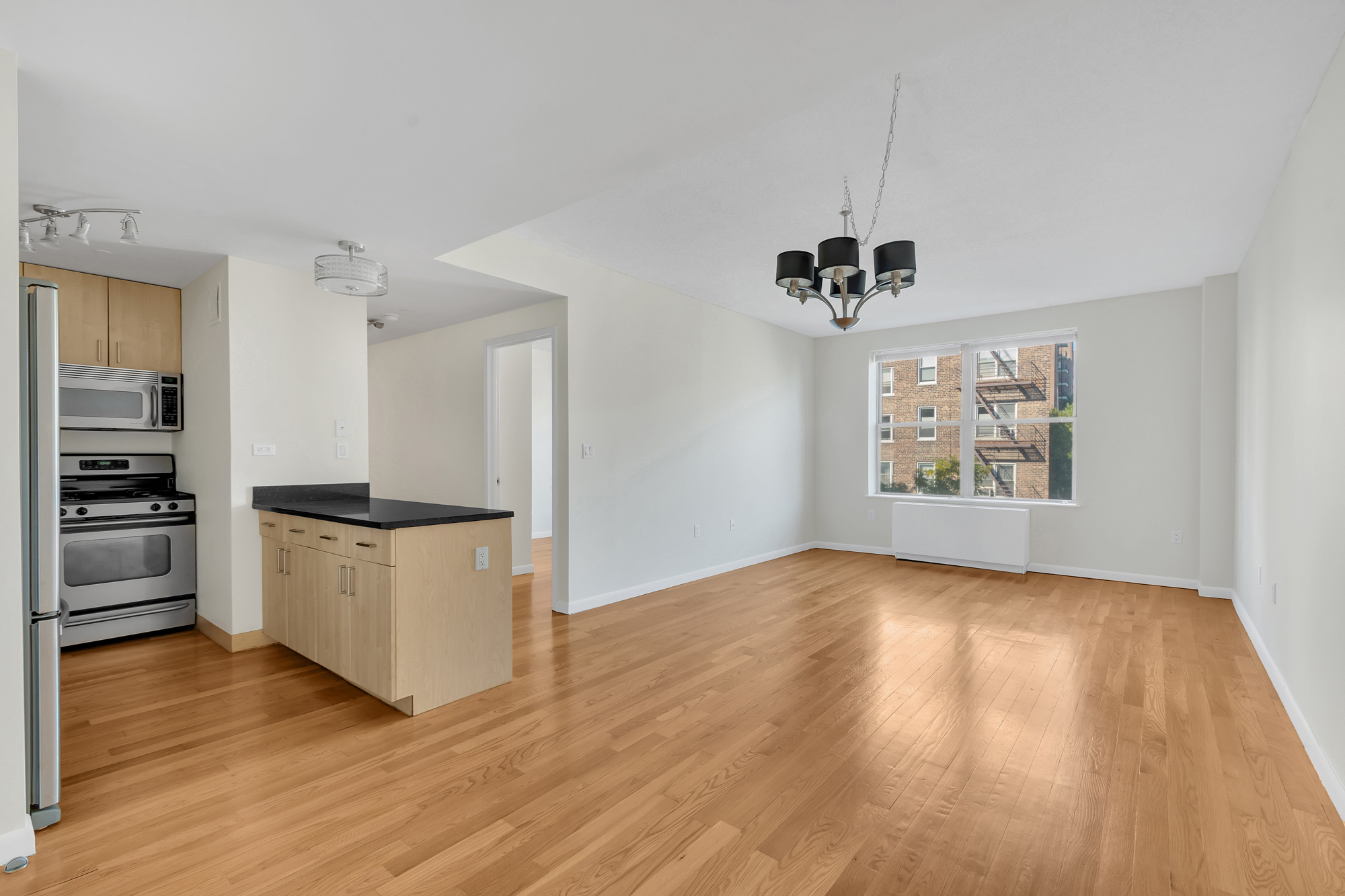 736 West 187th Street, Unit 502 Manhattan, NY 10033 - Photo 4 of 11 a view of a kitchen with a sink and a stove top oven