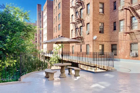 a view of a patio with couches and table and chairs and potted plants