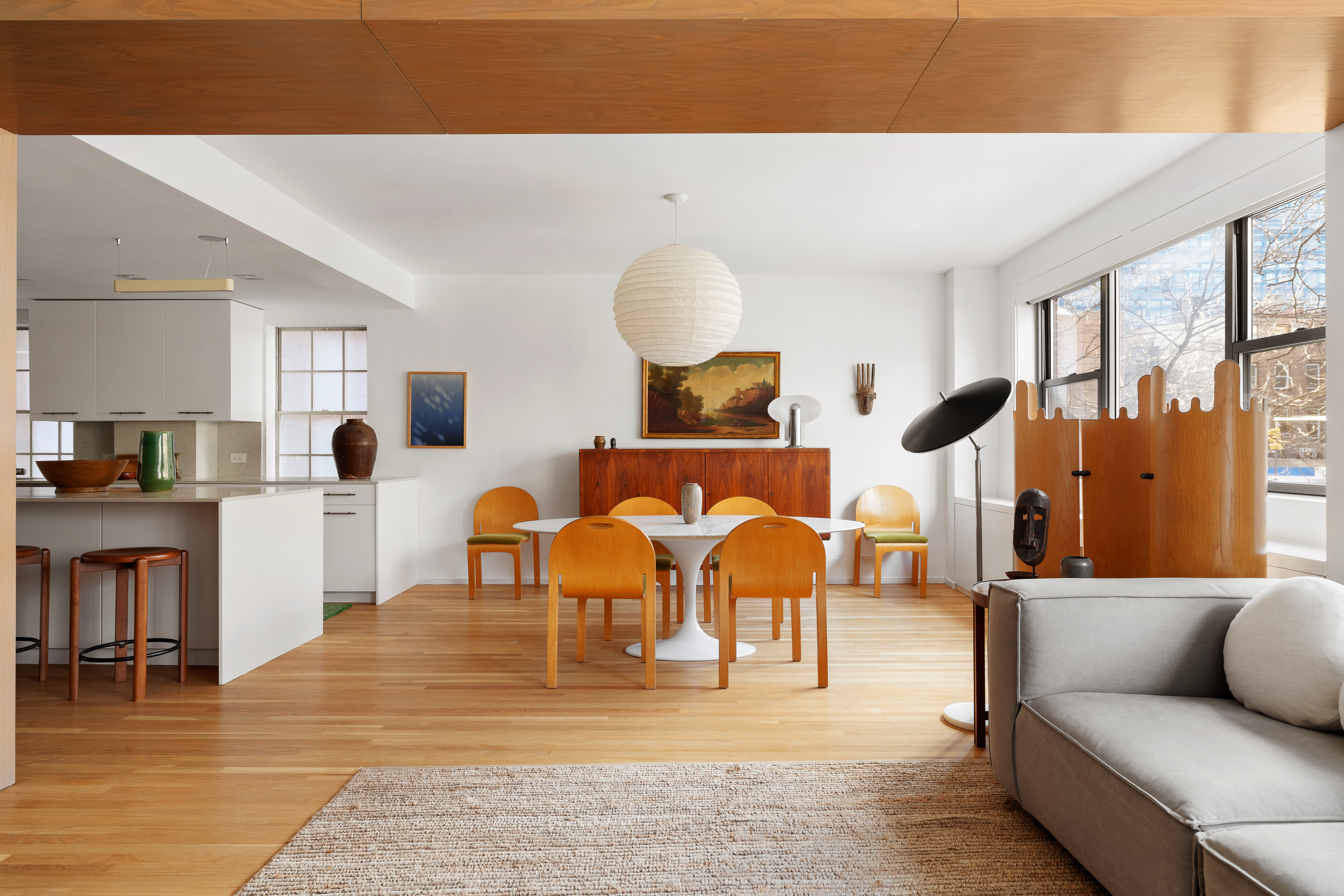 2 Horatio Street, Unit 2PR Manhattan, NY 10014 - Photo 2 of 14 a living room with couches and a dining table with wooden floor
