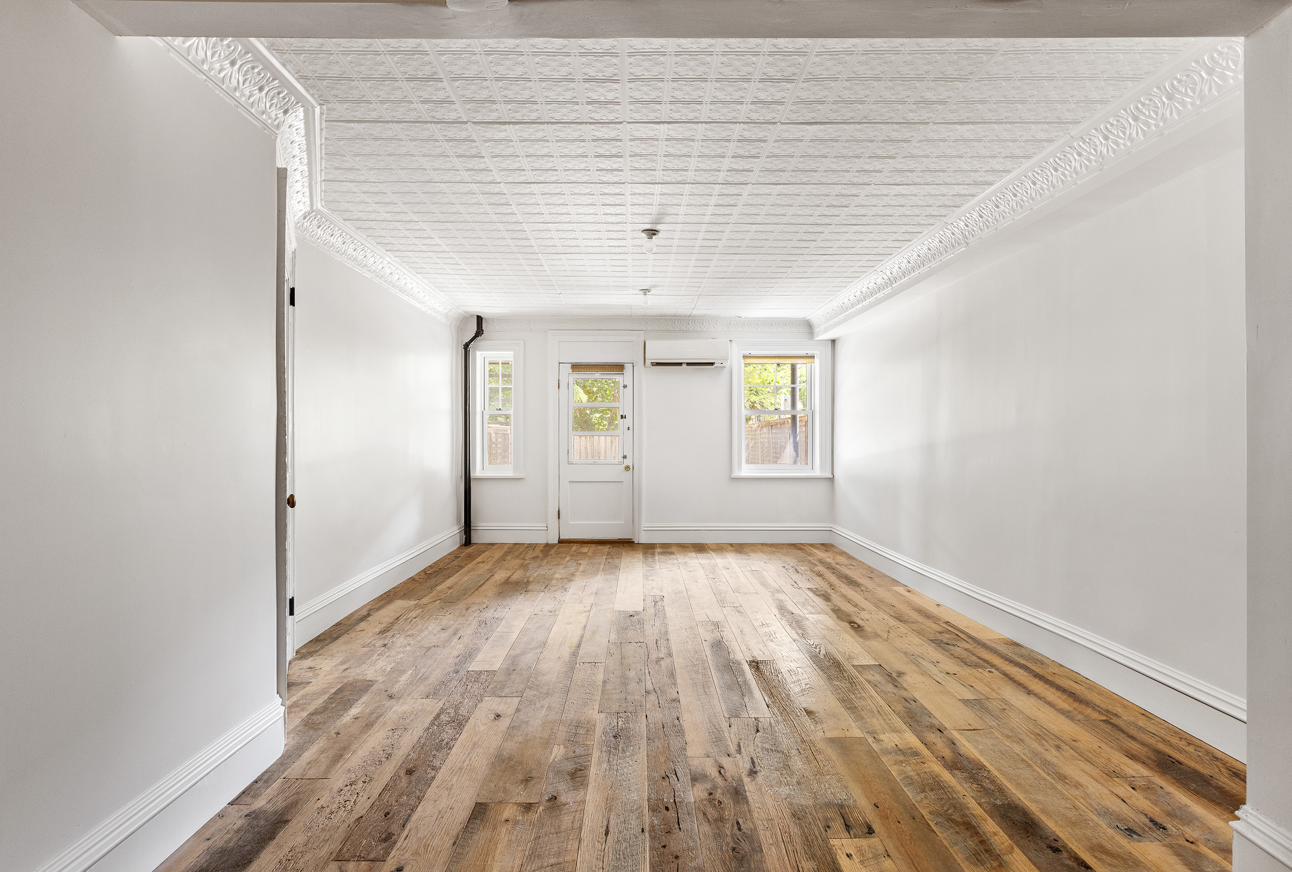 121 St James Place, Unit GARDEN Brooklyn, NY 11238 - Photo 2 of 8 an empty room with wooden floor and windows