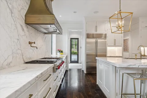 a kitchen with stainless steel appliances a sink stove and refrigerator