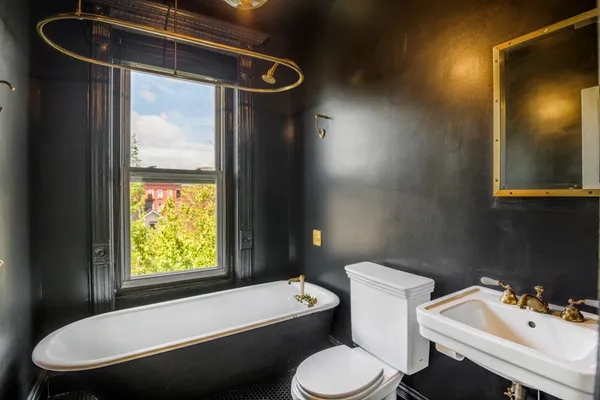 a bathroom with a sink toilet and a mirror