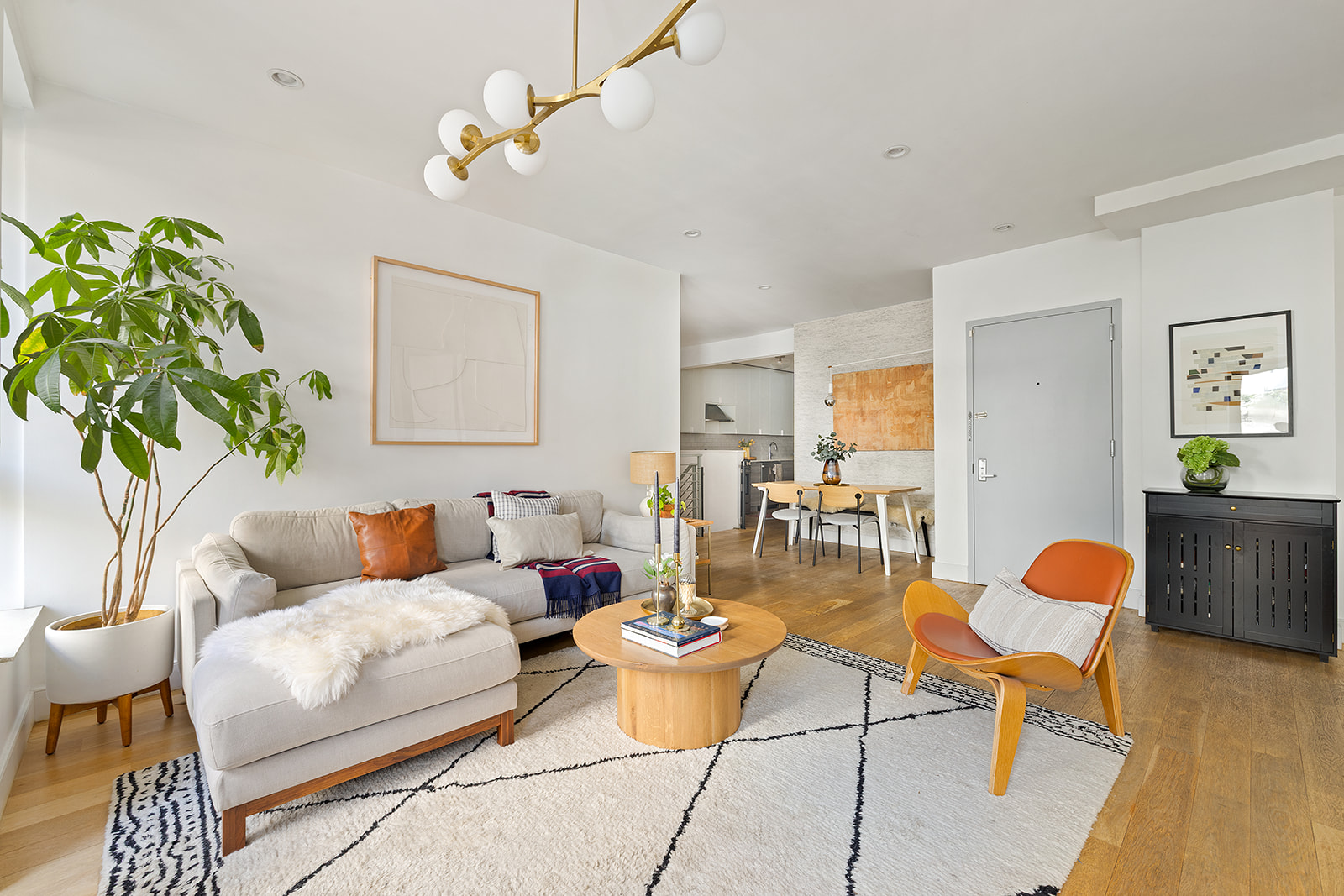 516 Classon Avenue, Unit 1B Brooklyn, NY 11238 - Photo 4 of 17 a living room with furniture a rug and a chandelier