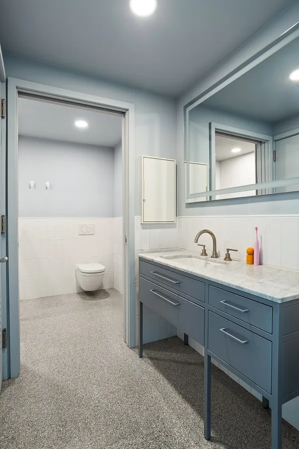 a spacious bathroom with a sink a toilet and a mirror