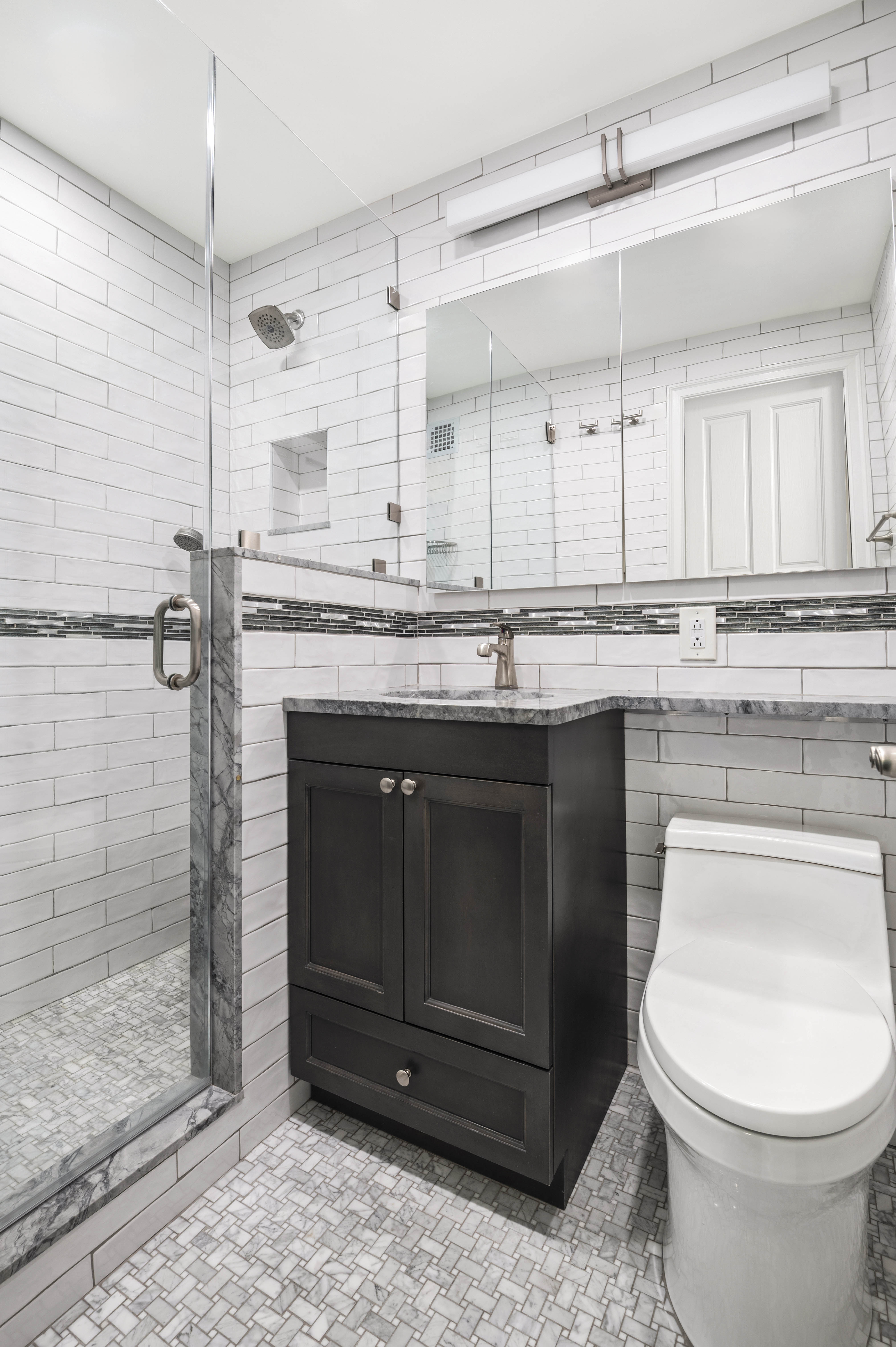 165 West End Avenue, Unit 5A Manhattan, NY 10023 - Photo 5 of 17 a bathroom with a sink a toilet and shower