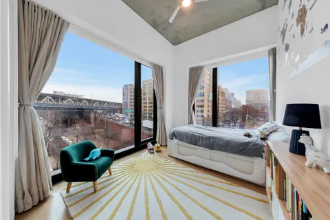 a bedroom with a bed and large window