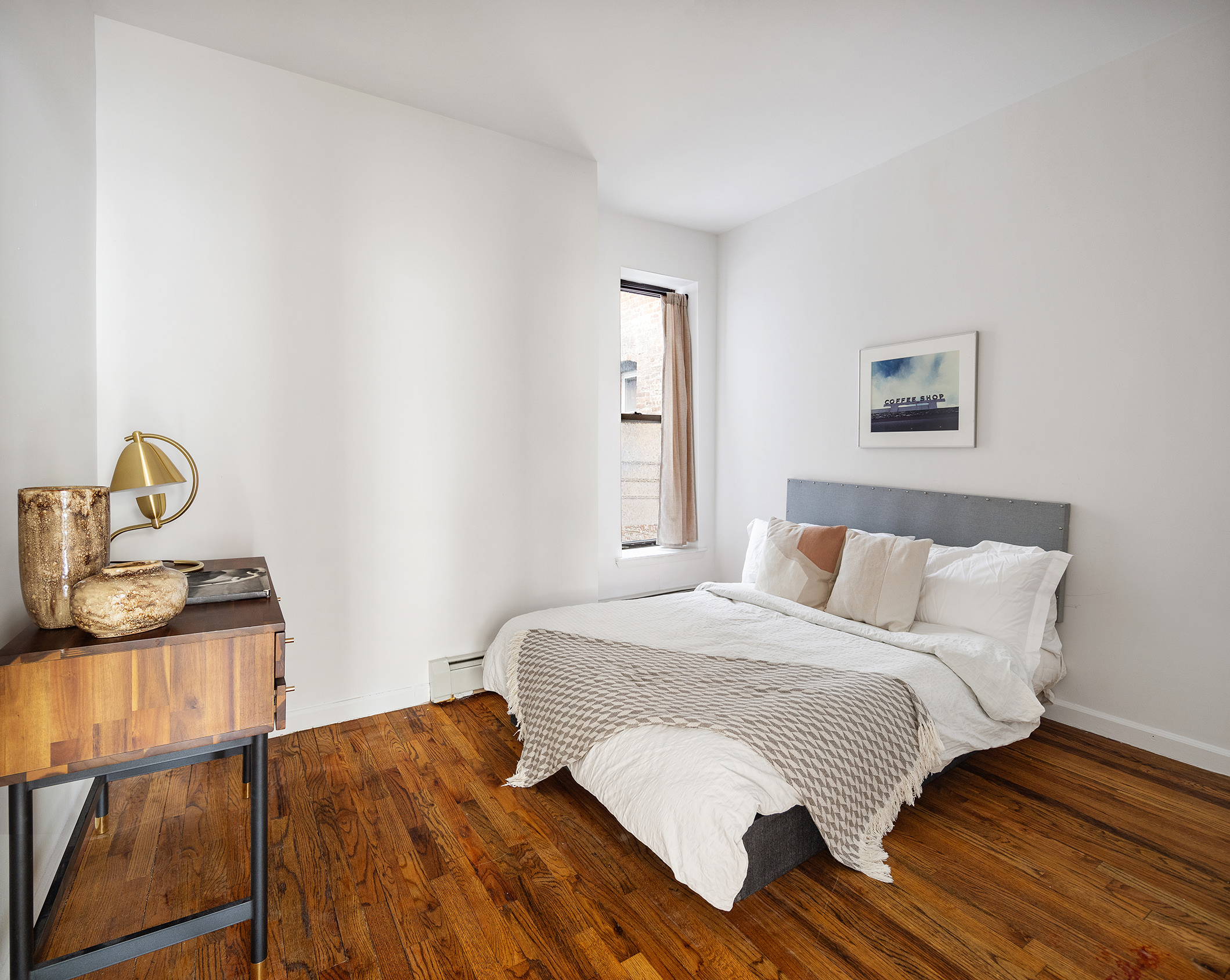 246 Sumpter Street, Unit 1C Brooklyn, NY 11233 - Photo 5 of 12 a bedroom with a bed and wooden floor