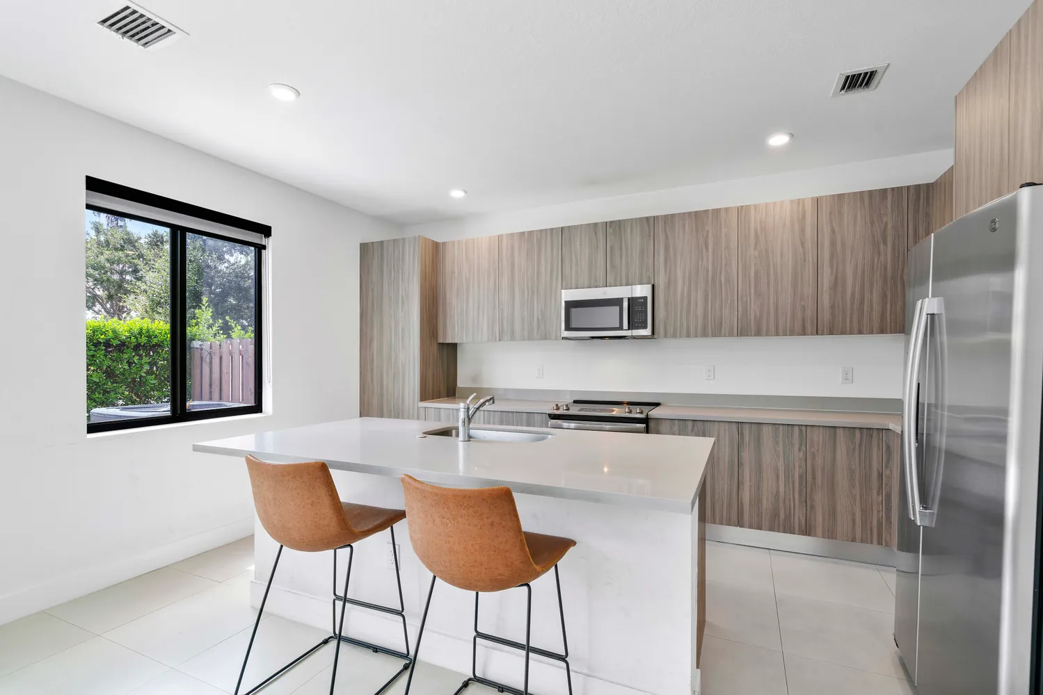a kitchen with stainless steel appliances a stove a refrigerator sink and cabinets