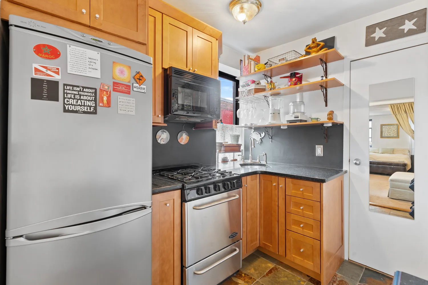 a kitchen with stainless steel appliances granite countertop a stove and a refrigerator