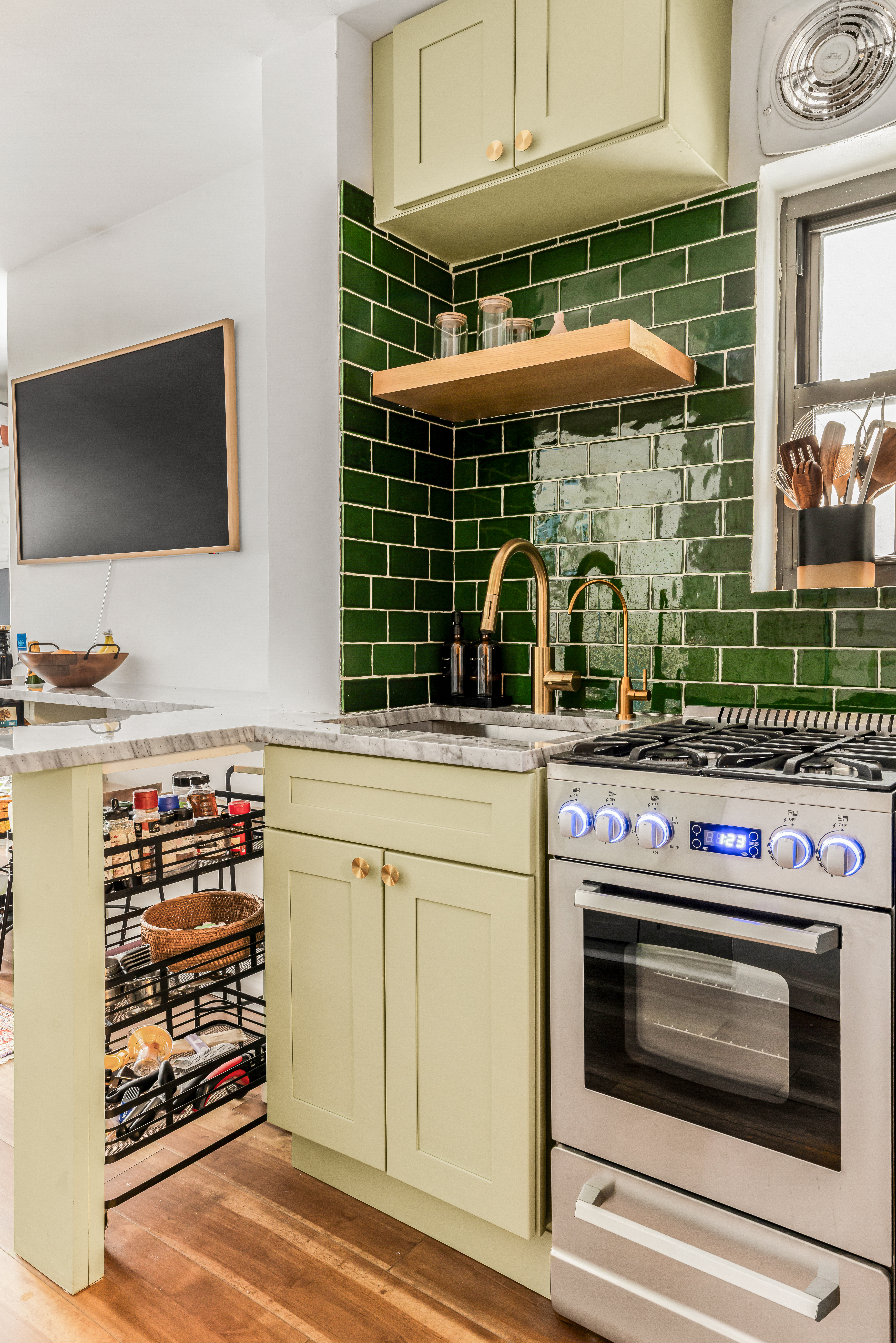15 Jones Street, Unit 5D Manhattan, NY 10014 - Photo 3 of 7 a kitchen with stainless steel appliances a stove and a microwave