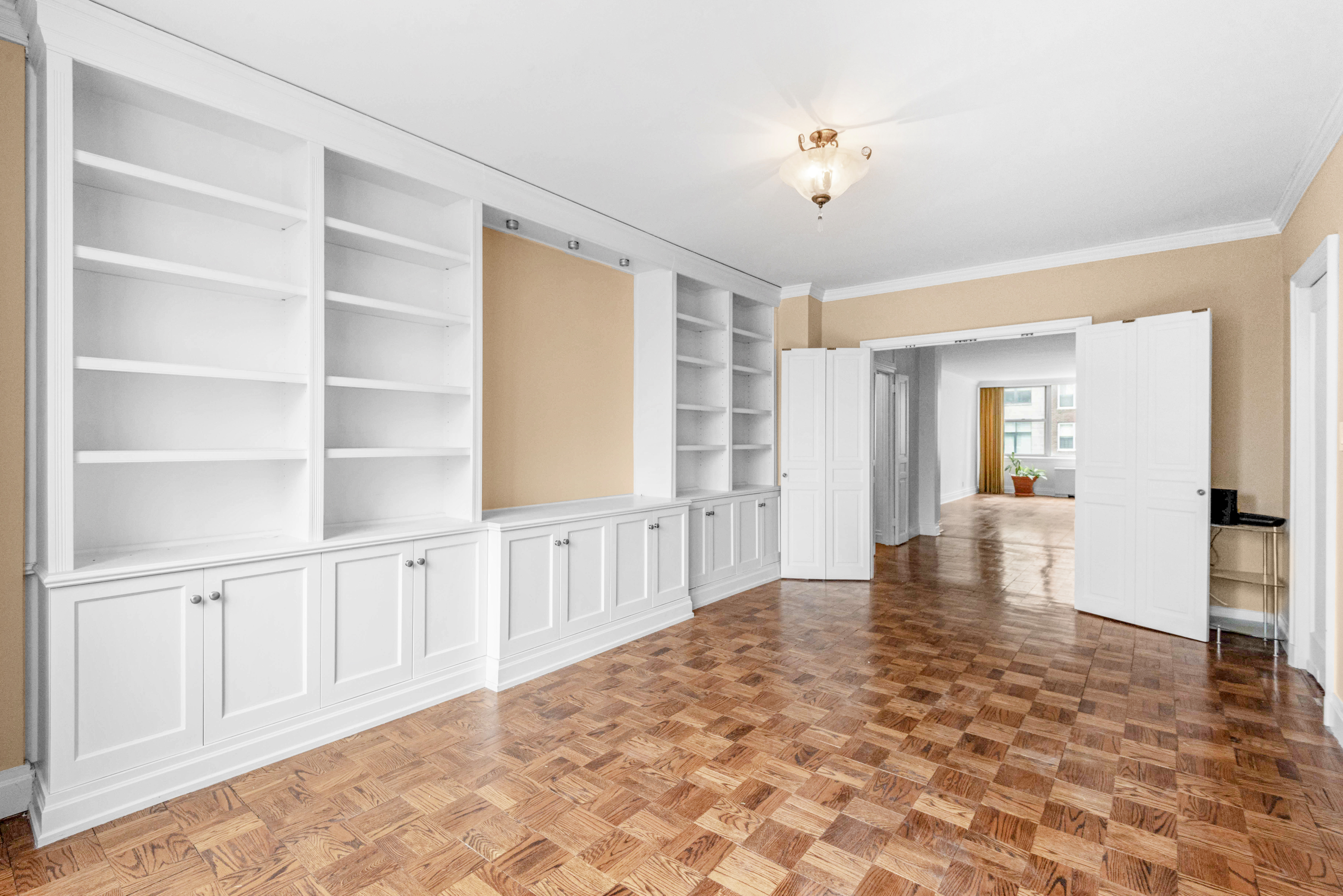 175 East 62nd Street, Unit 12A Manhattan, NY 10065 - Photo 17 of 24 a view of an empty room with window and stairs