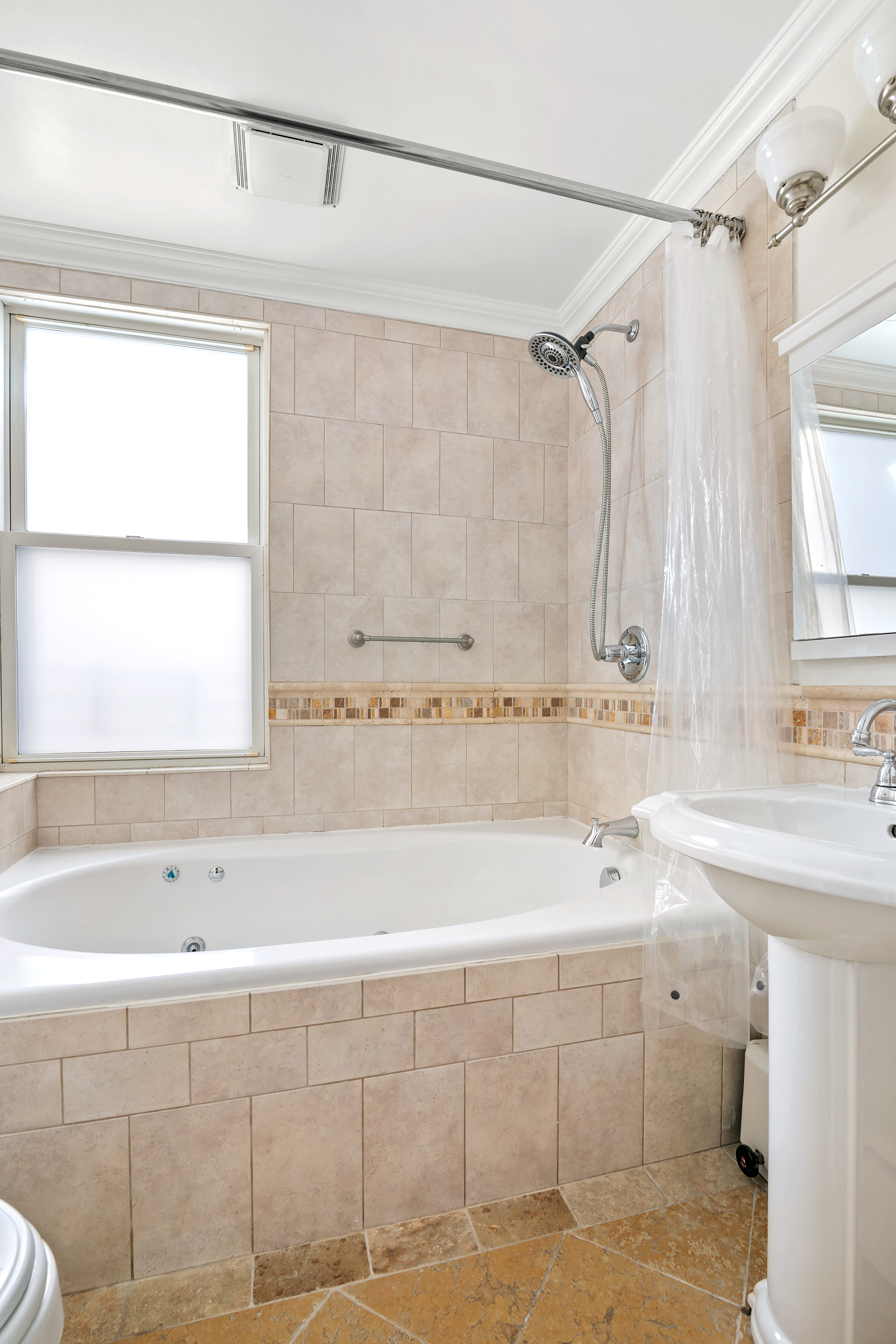 41-27 39th Place Queens, NY 11104 - Photo 6 of 13 a bathroom with a sink and a bathtub