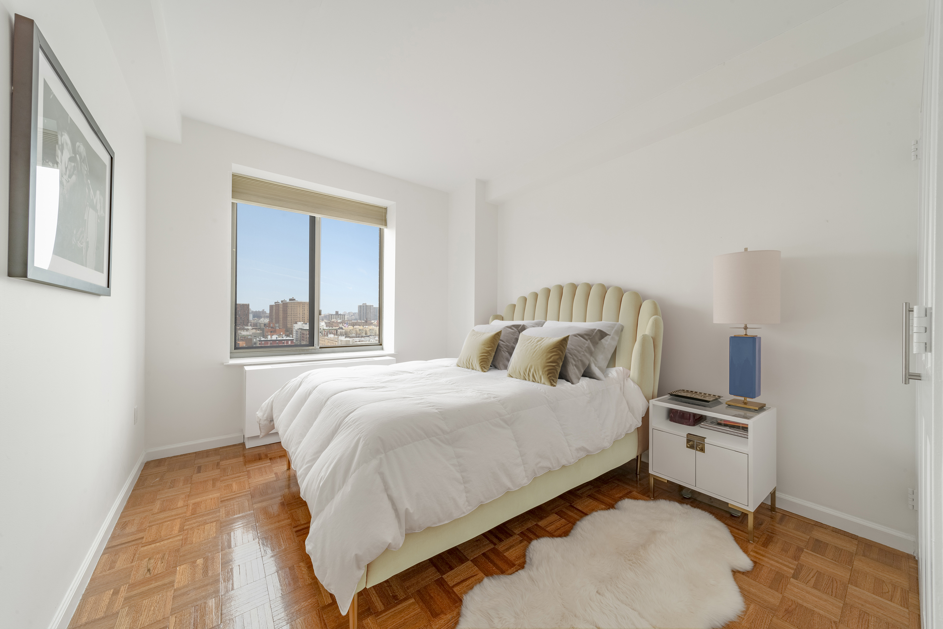 300 West 135th Street, Unit 12C Manhattan, NY 10030 - Photo 6 of 9 a bedroom with a bed and a window