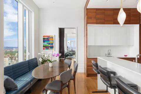 a dining room with furniture and wooden floor