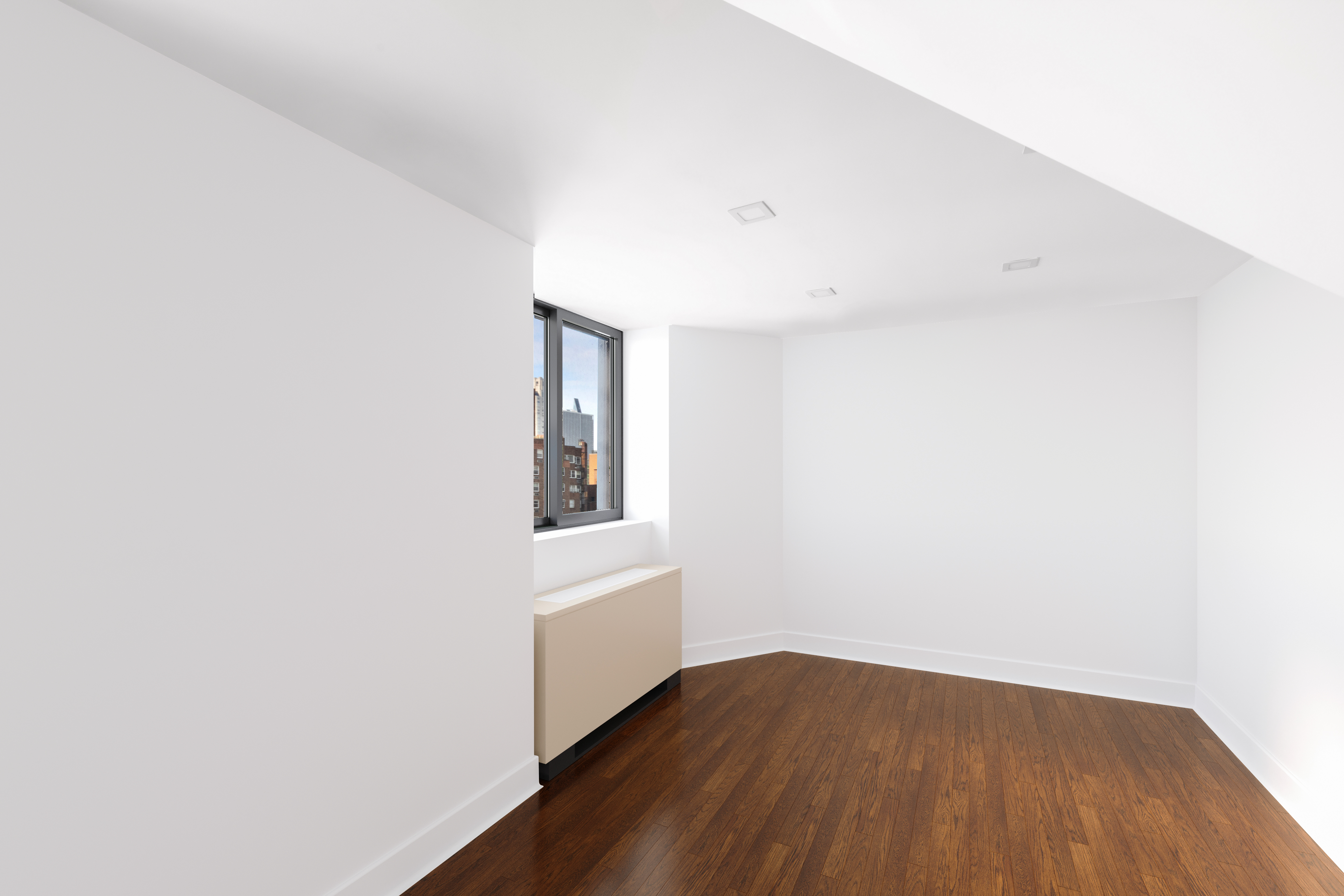 421 Hudson Street, Unit 325 Manhattan, NY 10014 - Photo 4 of 11 a view of an empty room with wooden floor and a window