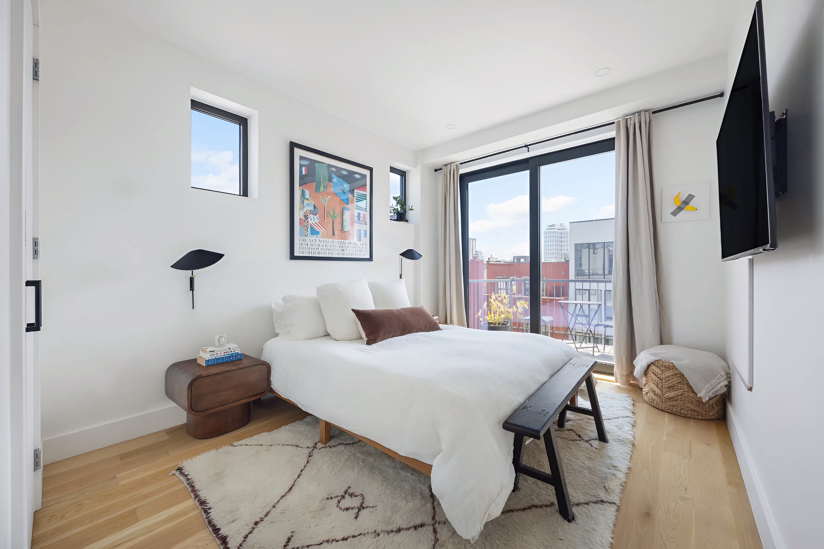 340 Metropolitan Avenue, Unit PHB Brooklyn, NY 11211 - Photo 10 of 18 a bedroom with a bed and a flat screen tv