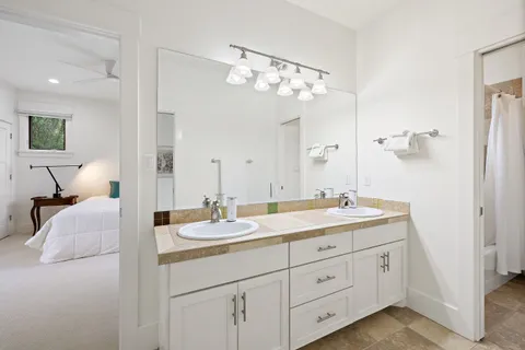 a bathroom with a sink a toilet and a mirror