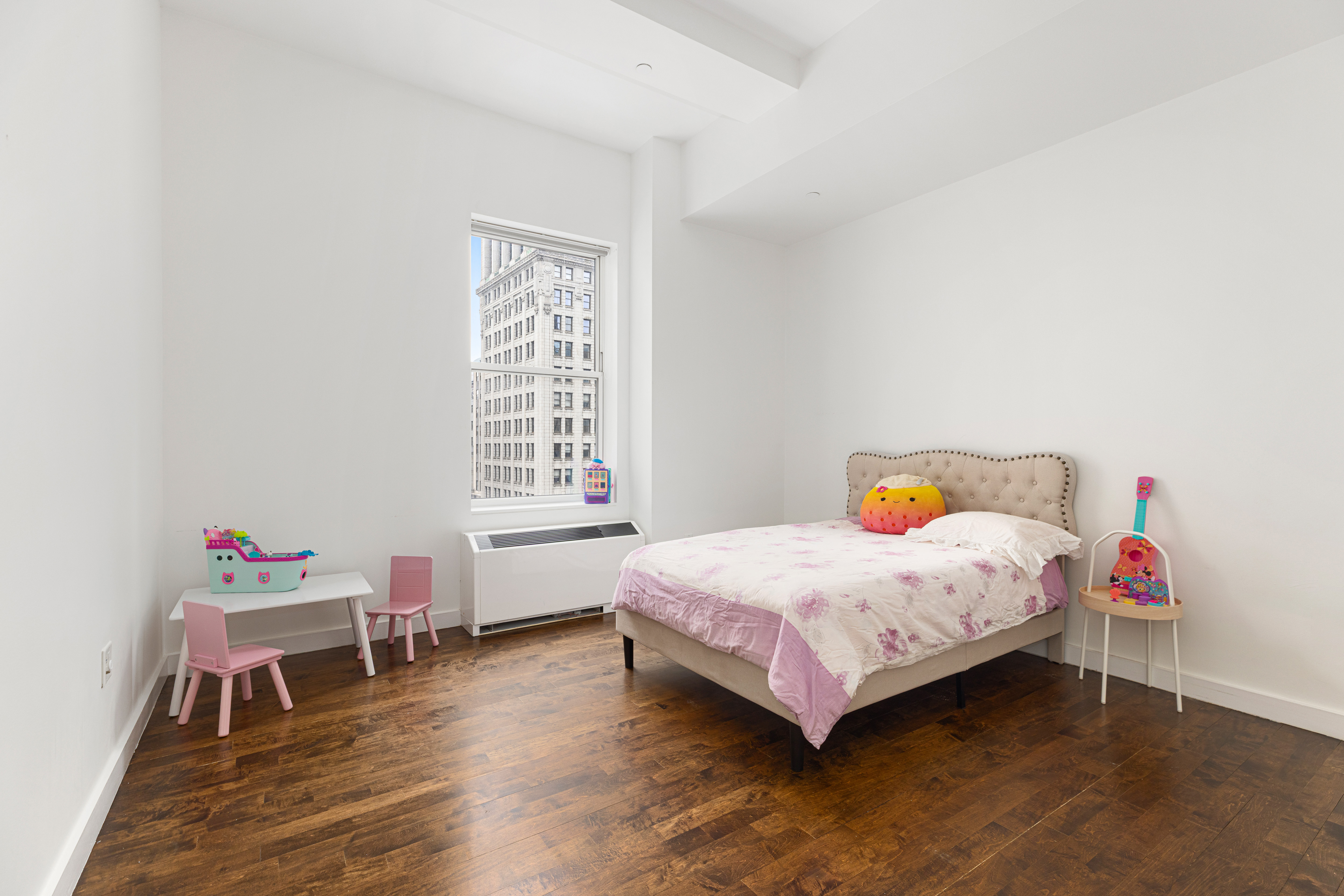 15 Broad Street, Unit 2300 Manhattan, NY 10005 - Photo 11 of 36 a bedroom with a bed and a window
