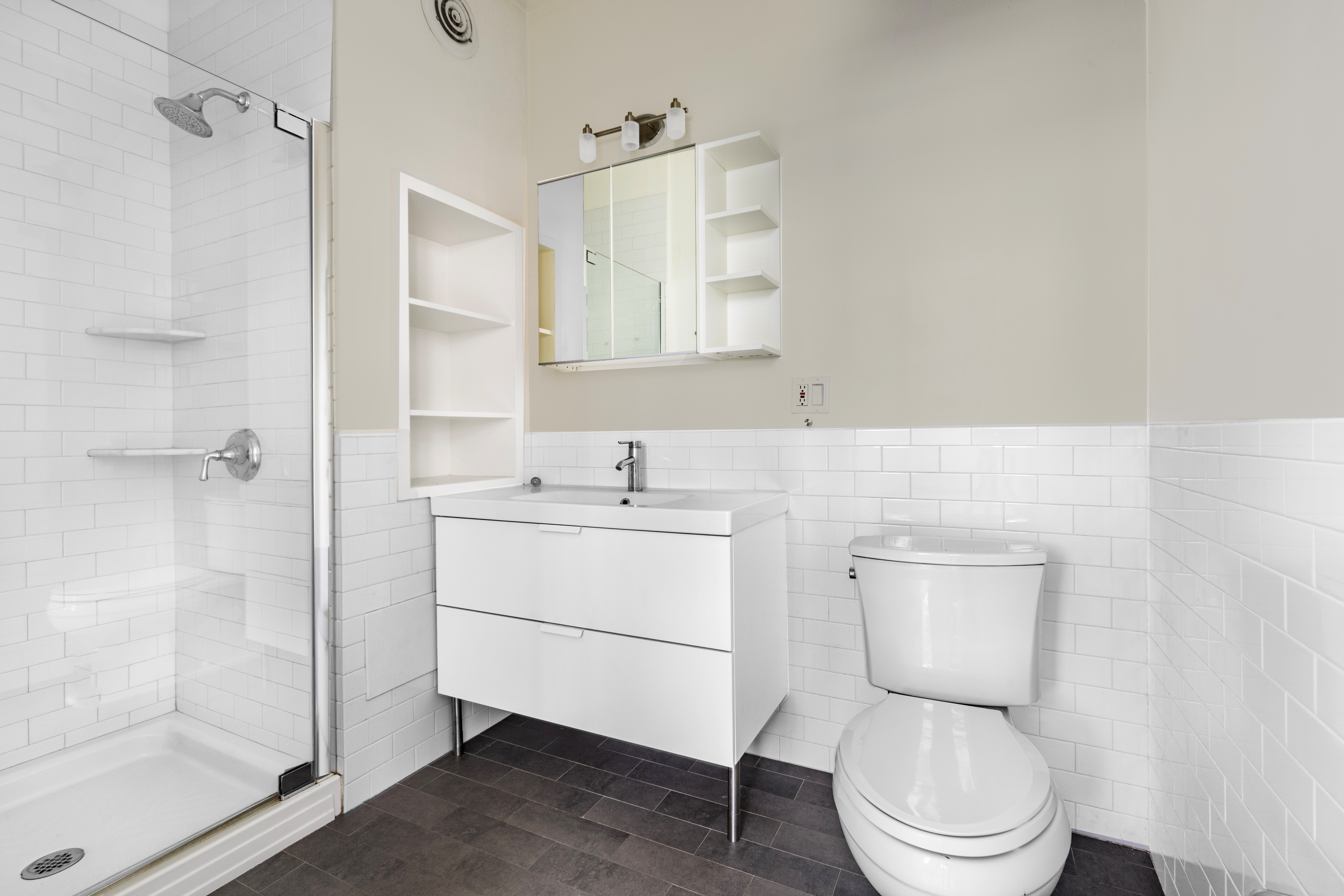 10 Leonard Street, Unit 6N Manhattan, NY 10013 - Photo 10 of 12 a white toilet sitting next to a bathroom sink