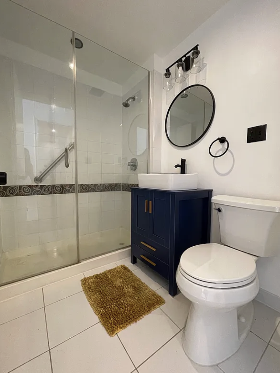 34 Crooke Avenue, Unit 4B Brooklyn, NY 11226 - Photo 5 of 12 a bathroom with a toilet a sink and a mirror