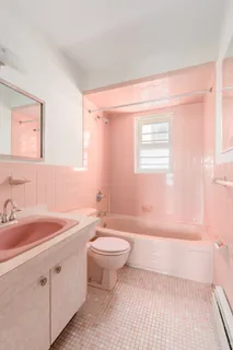 a bathroom with a sink a toilet and bathtub