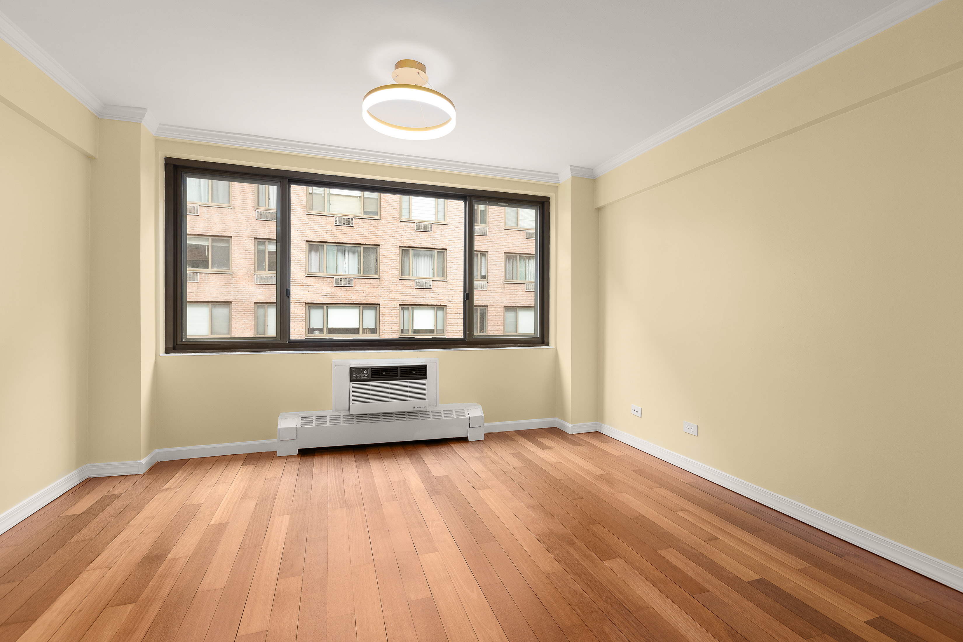 425 East 63rd Street, Unit E7A Manhattan, NY 10065 - Photo 7 of 13 a view of empty room with wooden floor and fan