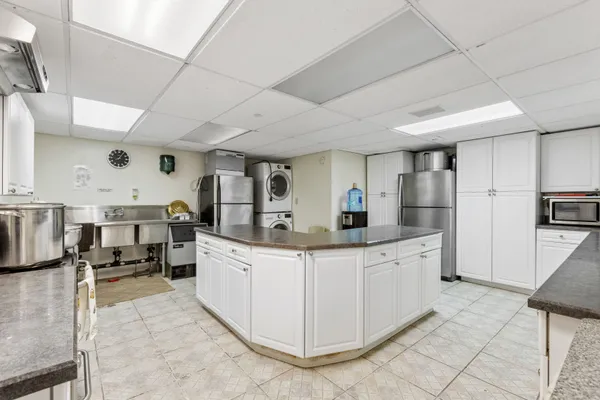 a kitchen with stainless steel appliances kitchen island granite countertop a sink and cabinets