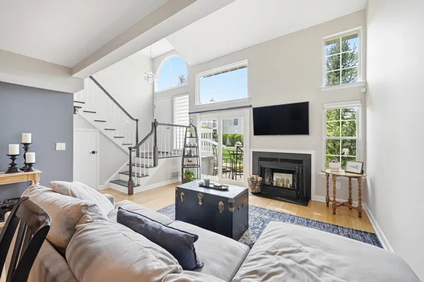 a living room with furniture a rug and a fireplace