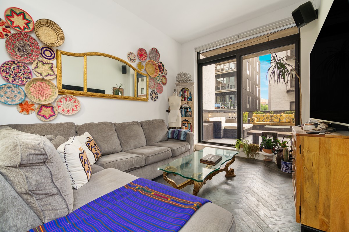 11-12 44th Drive, Unit 2B Queens, NY 11101 - Photo 4 of 15 a living room with furniture and flat screen tv