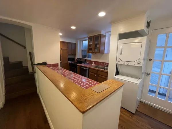a kitchen with stainless steel appliances a sink stove and refrigerator