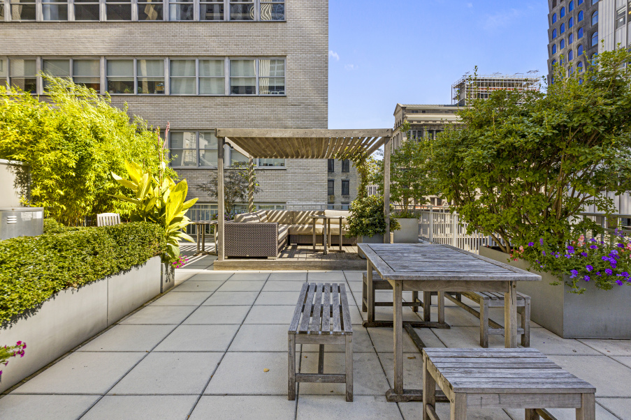 59 John Street, Unit 4H Manhattan, NY 10038 - Photo 15 of 19 a view of a patio with table and chairs and potted plants