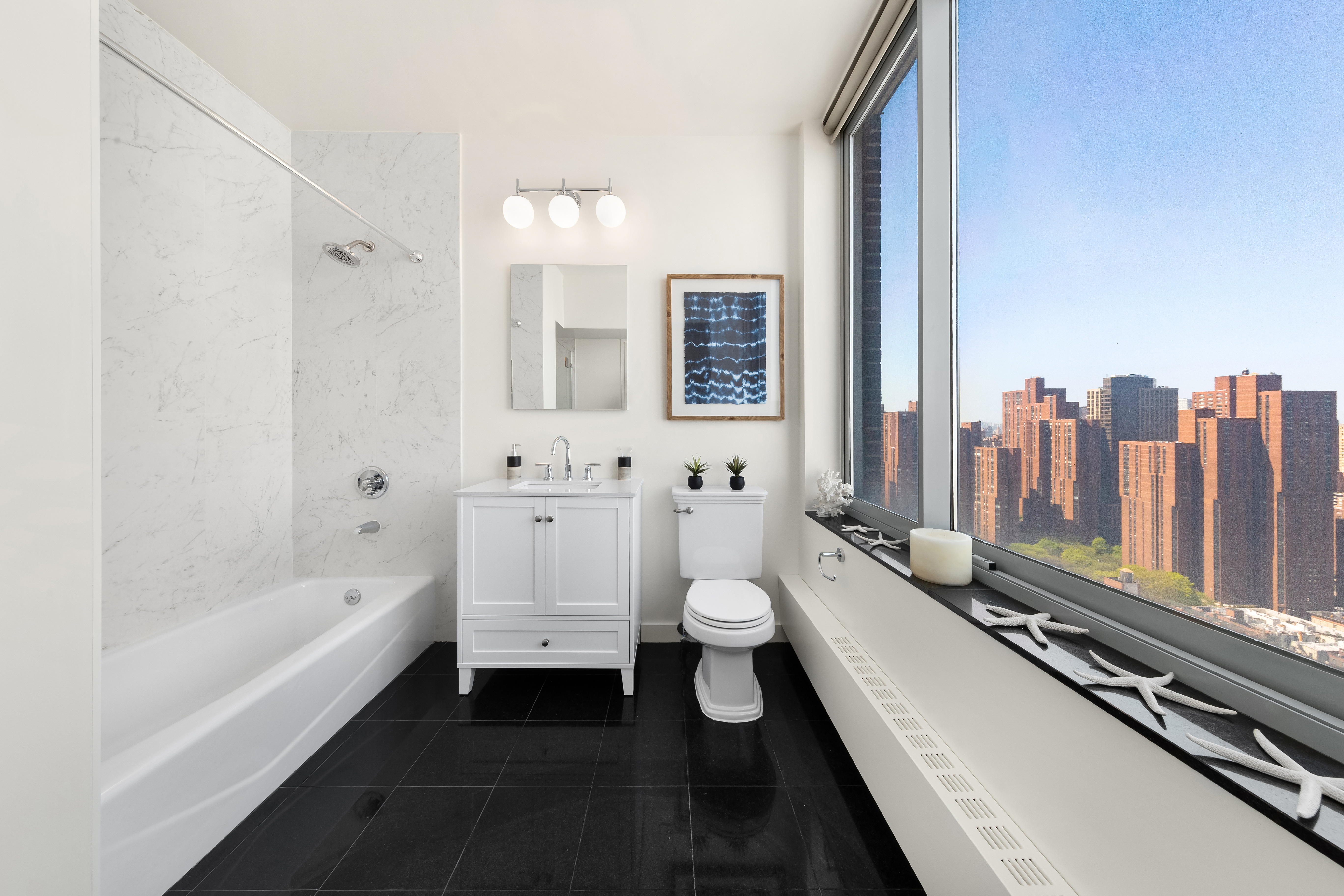 360 East 88th Street, Unit 31C Manhattan, NY 10128 - Photo 10 of 24 a bathroom with a double vanity sink a toilet and bathtub