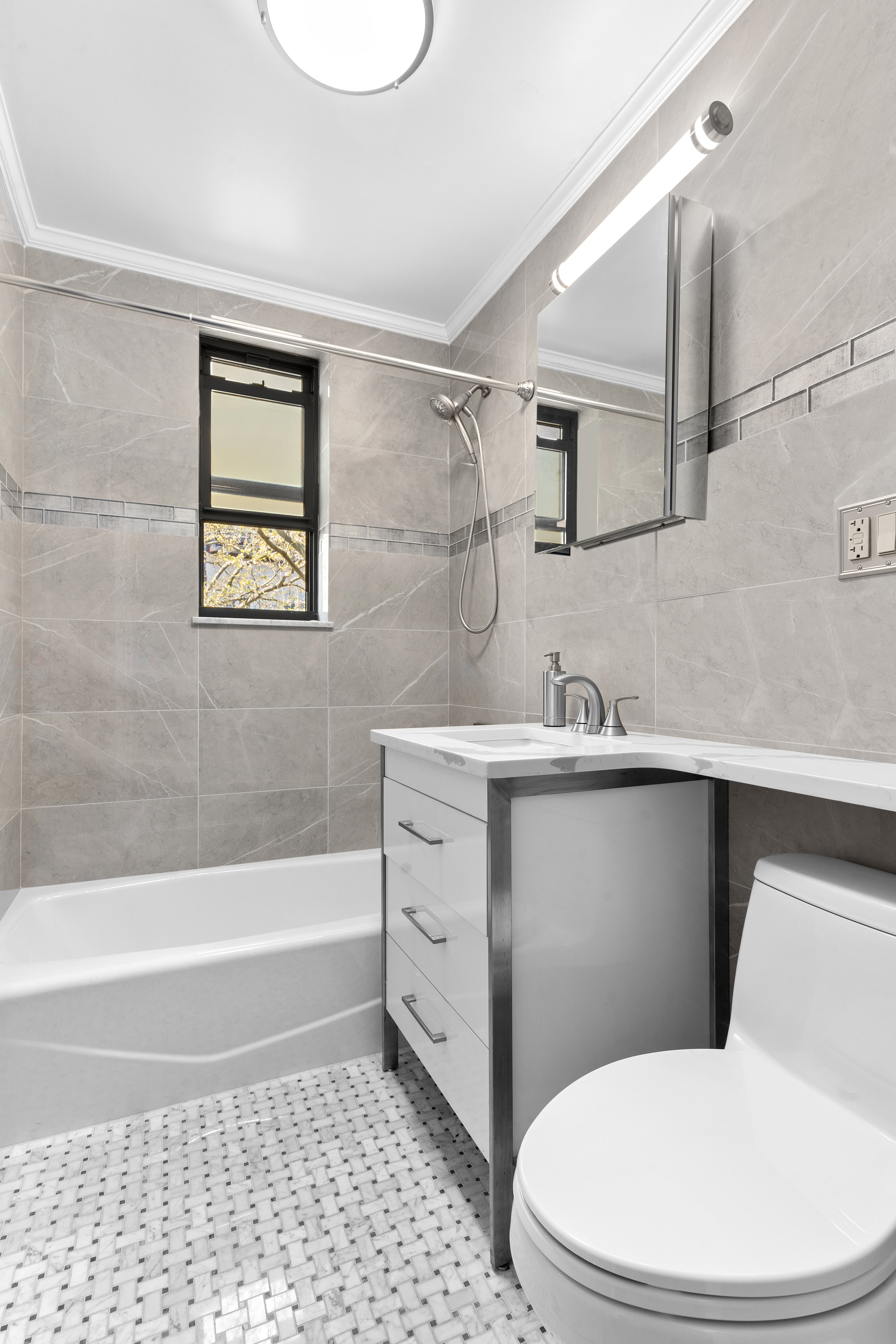 20 89th Street, Unit 5C Brooklyn, NY 11209 - Photo 8 of 9 a bathroom with a sink a toilet and bathtub