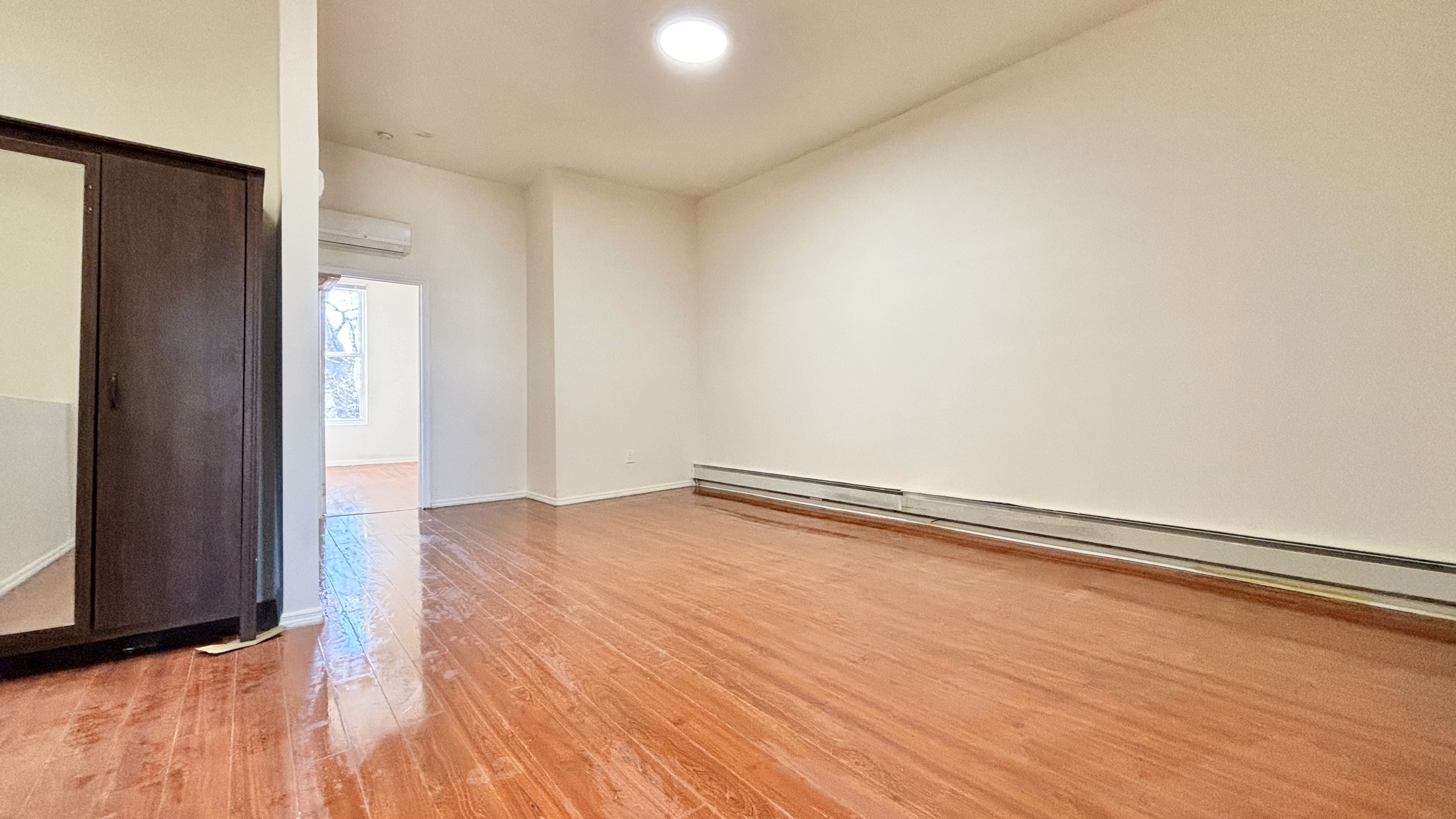 74 Himrod Street, Unit 2 Brooklyn, NY 11221 - Photo 5 of 16 a view of empty room with wooden floor