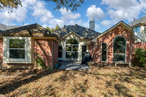 a view of a house with large windows and a yard
