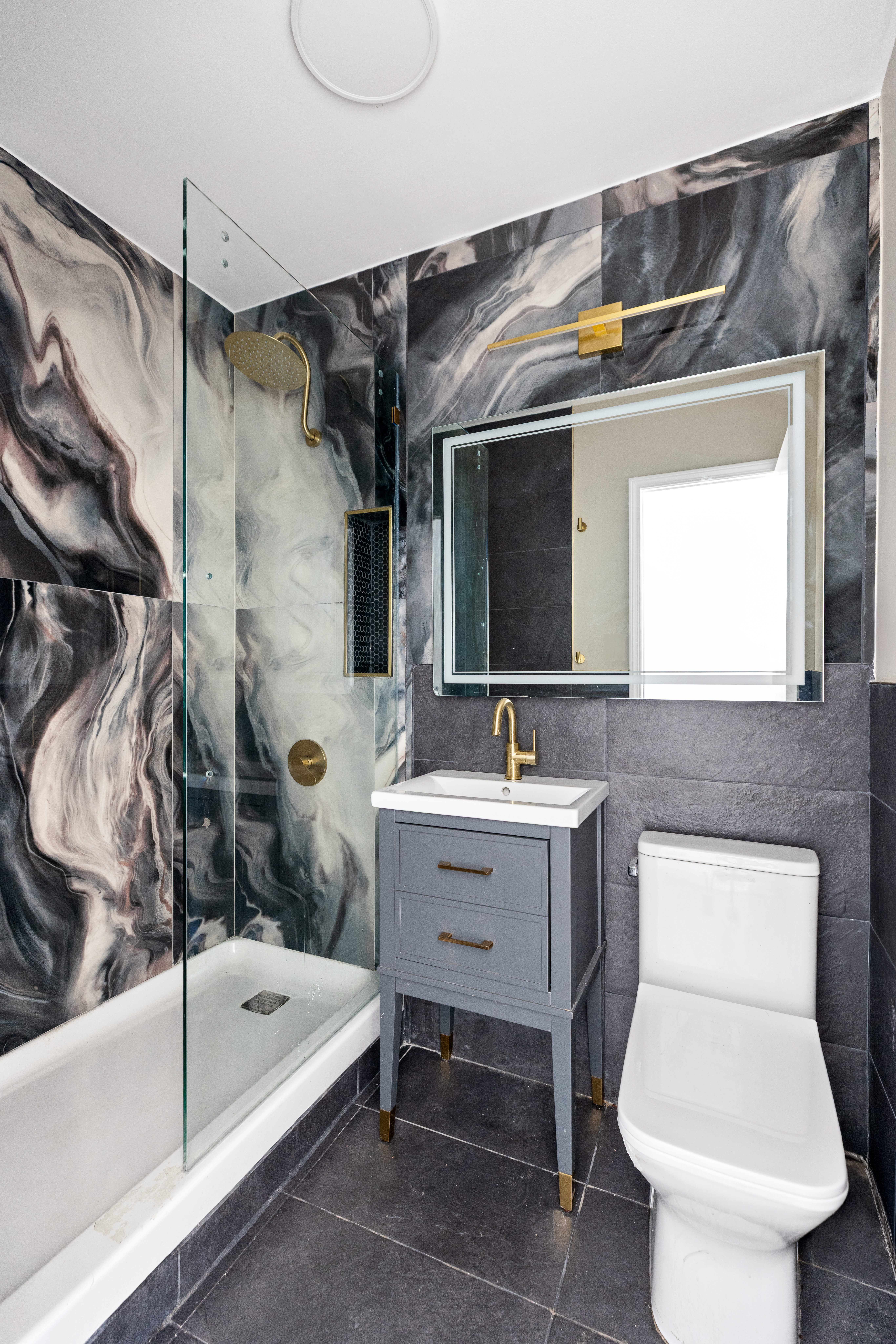 663 Greene Avenue Brooklyn, NY 11221 - Photo 7 of 14 a bathroom with a sink toilet and tub