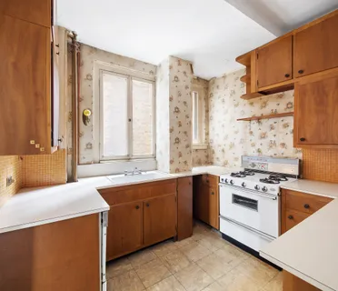 a kitchen with stainless steel appliances a stove a sink and a microwave
