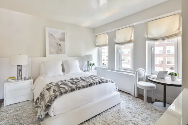 a bedroom with a large bed and a window