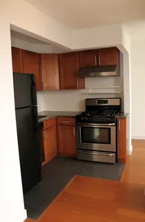 a kitchen with a refrigerator and a stove