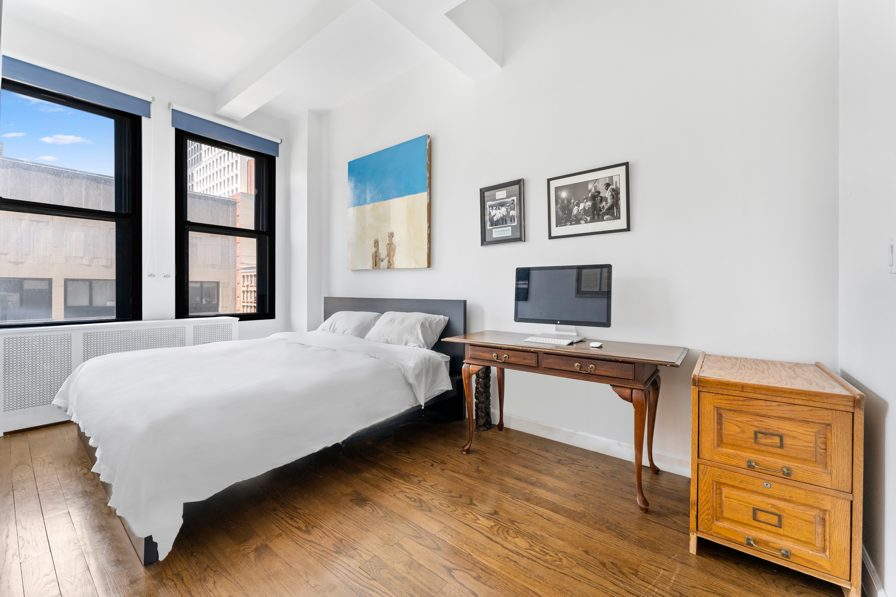 315 7th Avenue, Unit 5C Manhattan, NY 10001 - Photo 5 of 7 a bedroom with a bed and a flat screen tv