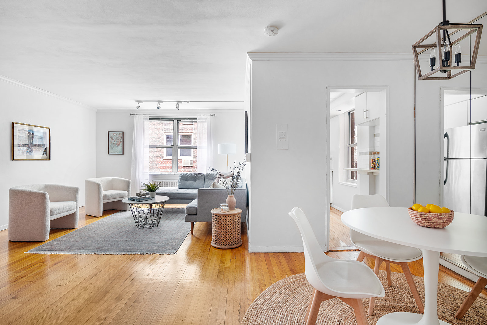 302 East 88th Street, Unit 3J Manhattan, NY 10128 - Photo 1 of 8 a living room with furniture and wooden floor