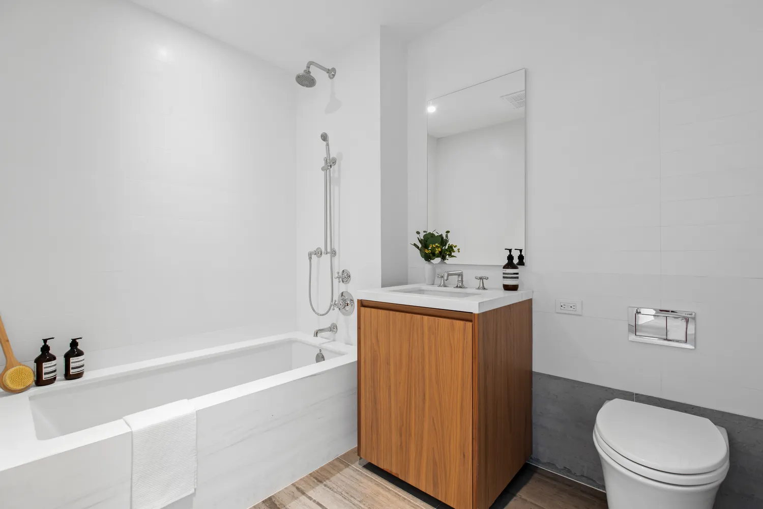 a bathroom with a granite countertop sink toilet and shower