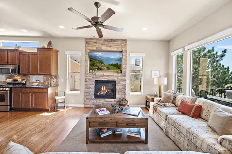 a living room with furniture a ceiling fan and a window