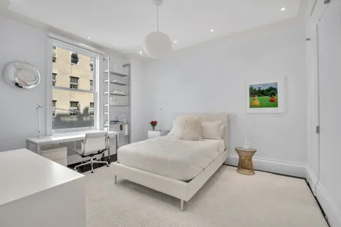 a bedroom with a bed and a table in it