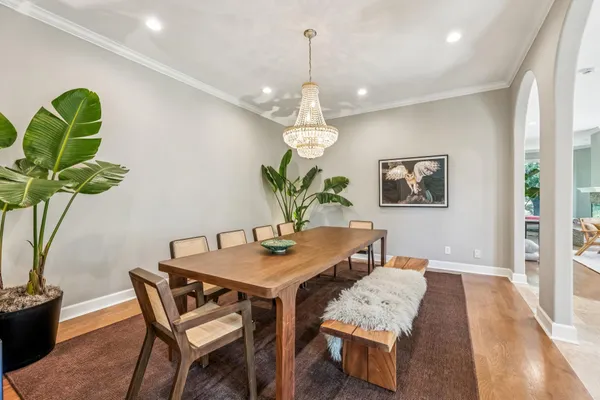 a view of a dining room with furniture wooden floor and chandelier