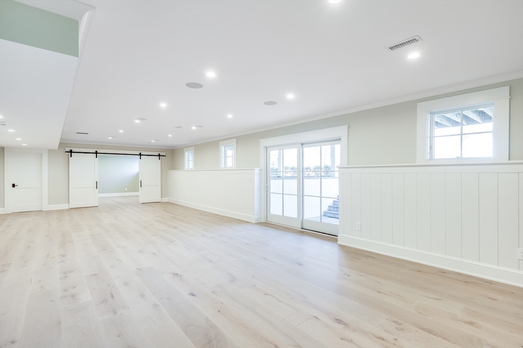 181 Dedham Street Dover, MA 02030 - Photo 9 of 19 an empty room with wooden floor and windows