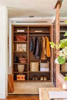 a view of walk in closet with clothes and shoes