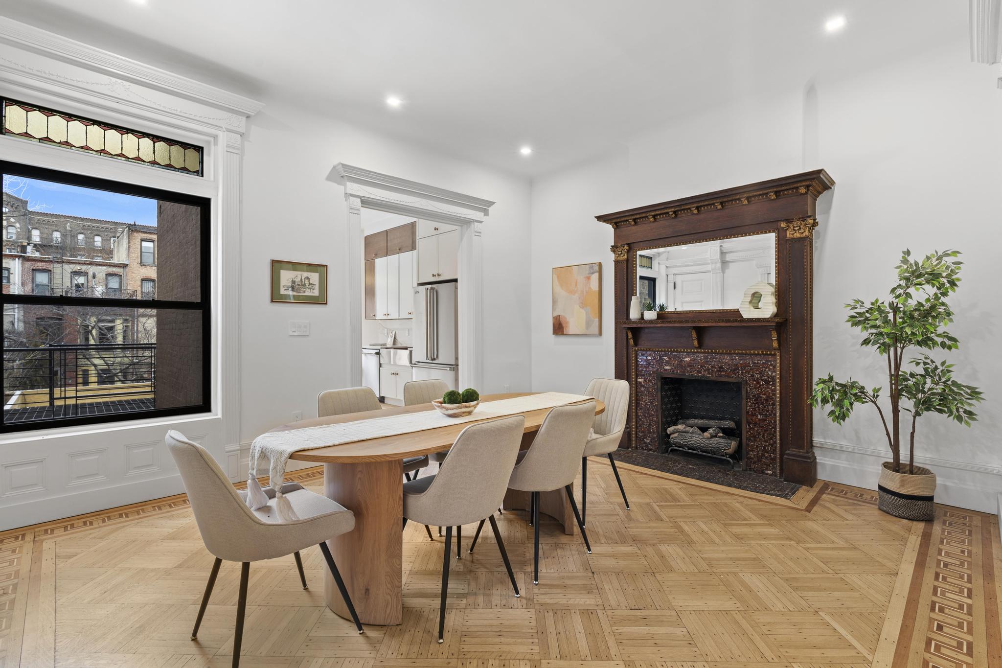 987 Sterling Place Brooklyn, NY 11213 - Photo 3 of 16 a dining room with furniture and a fireplace